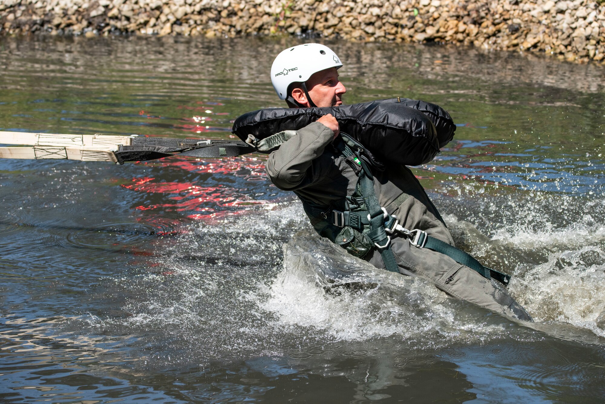 U.S. Air Force Lt. Col. Brian Cherolis, an F-16 fighter pilot assigned to the Ohio National Guard’s 180th Fighter Wing is dragged through the water during water survival training in Waterville, Ohio, Aug. 8, 2020.