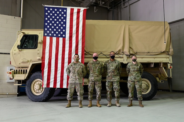 Four Airmen in uniform posing for photo