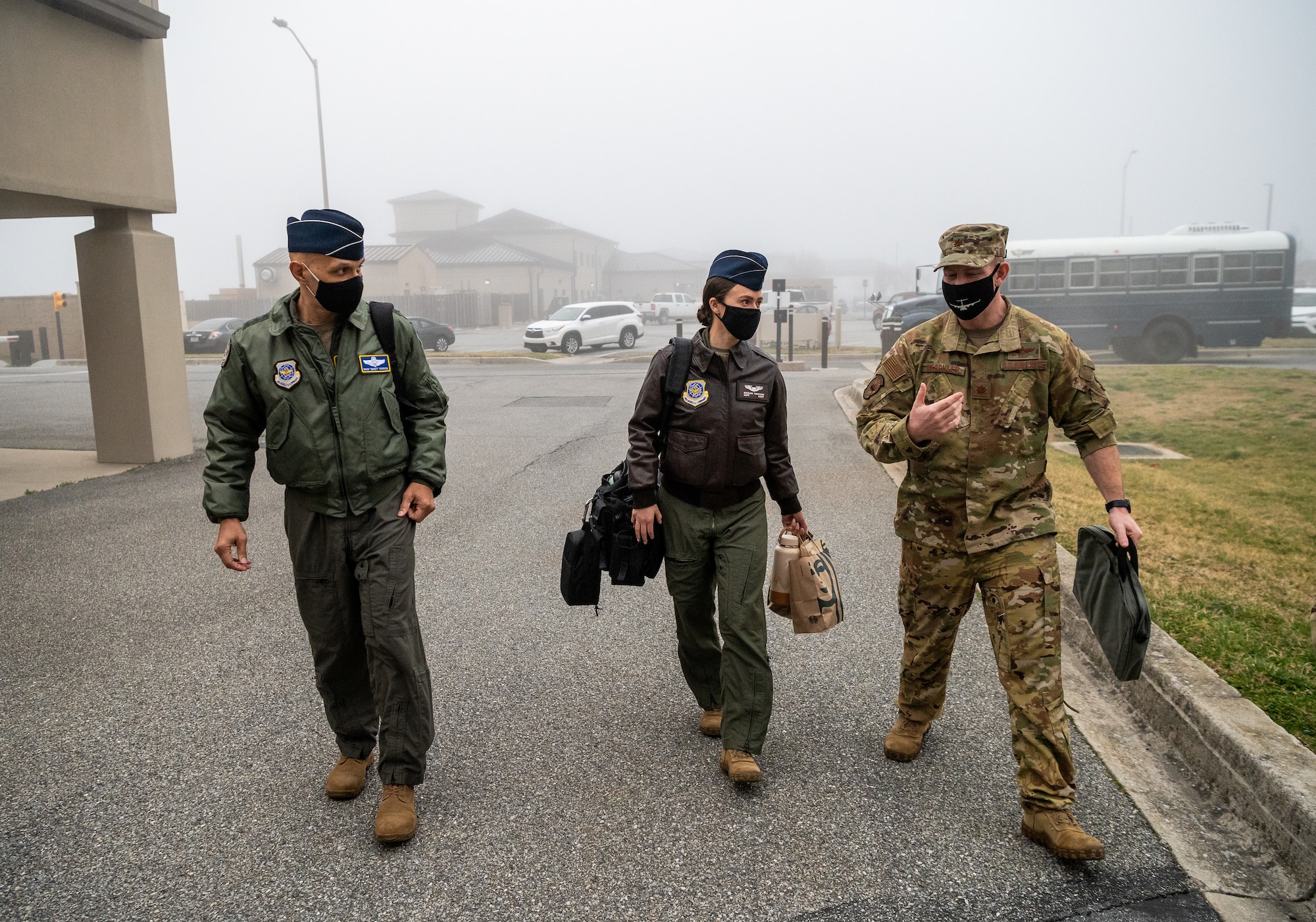 From left, U.S. Air Force Airmen Lt. Gen. Brian Robinson, Air Mobility Command deputy commander, Capt. Kaitlyn Tinkham, AMC executive officer to the deputy commander, and Maj. Steven Beachler, 3rd Airlift Squadron pilot, walk to the base operations building prior to a flight at Dover Air Force Base, Delaware, March 23, 2021. Robinson visited Dover AFB to engage with base leaders and fulfill training requirements on the C-17 Globemaster III. (U.S. Air Force photo by Senior Airman Christopher Quail)