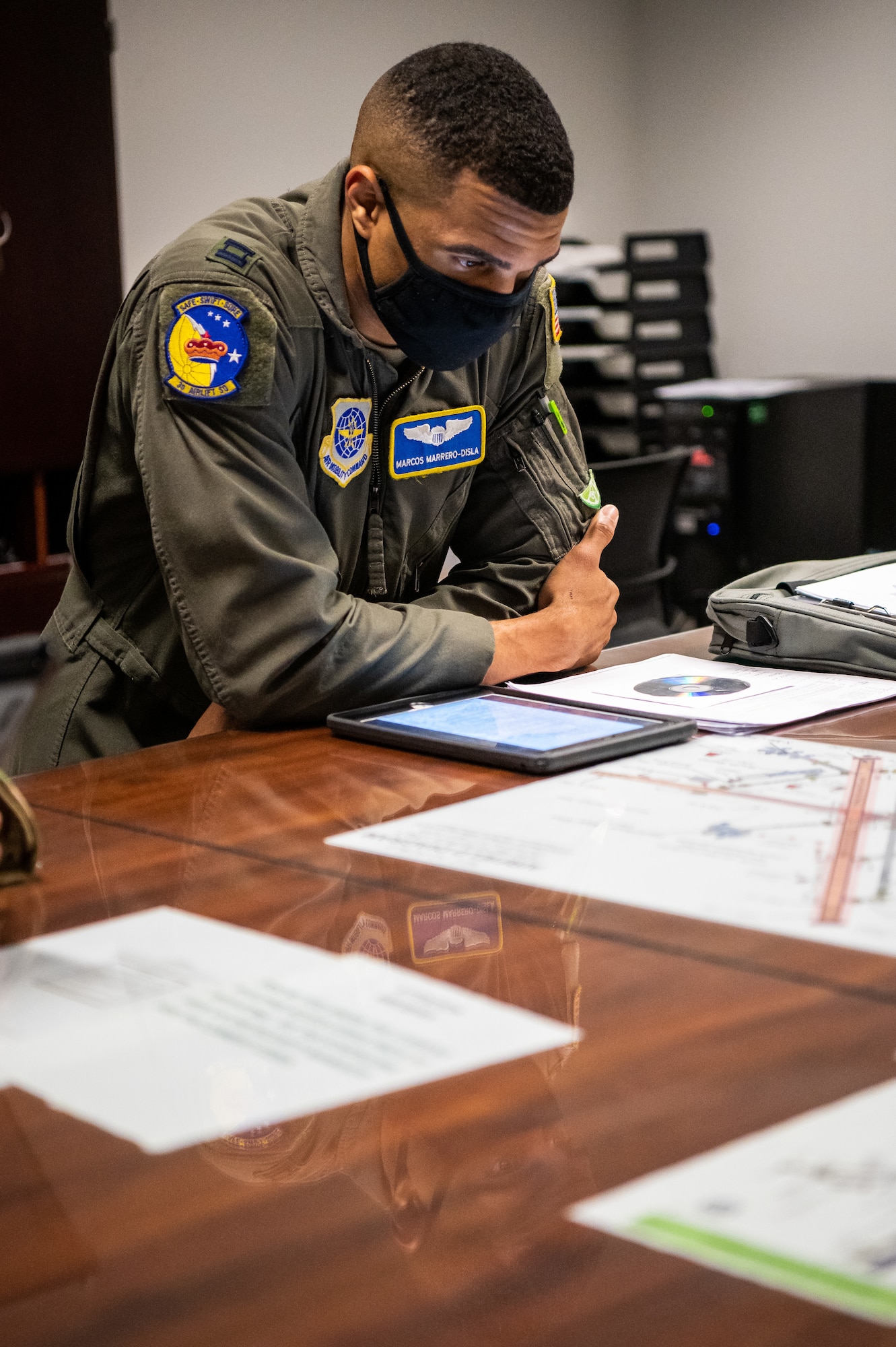 U.S. Air Force Capt. Marcos Marrero-Disla, 3rd Airlift Squadron pilot, examines documents during a preflight brief at Dover Air Force Base, Delaware, March 23, 2021. A preflight brief allows aircrew members to communicate important information to one another ensuring they understand safety procedures and mission plans. (U.S. Air Force photo by Senior Airman Christopher Quail)