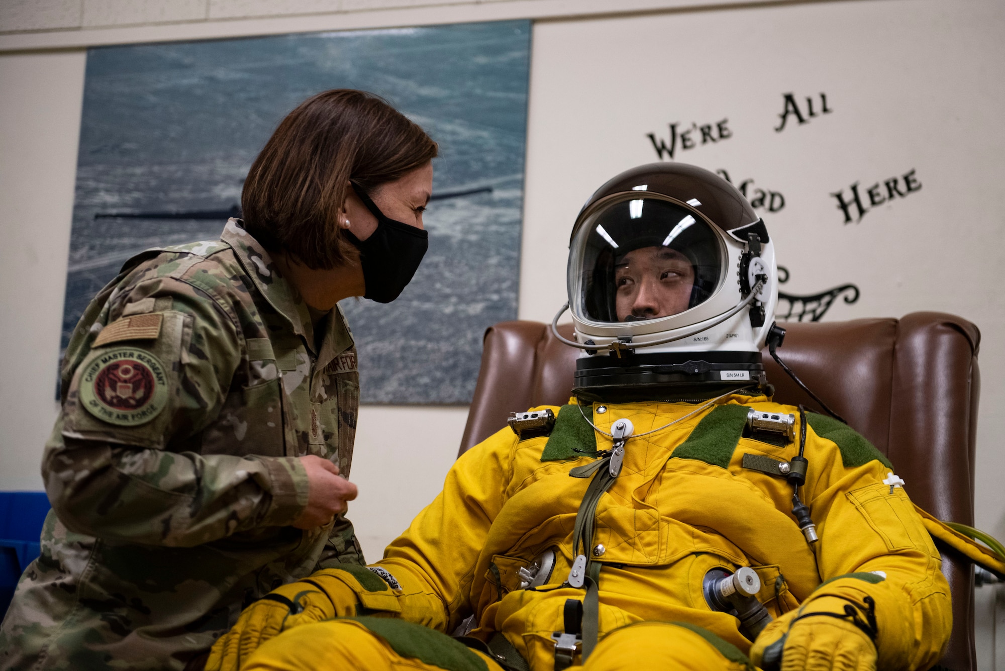 Chief Master Sgt. of the Air Force JoAnne Bass, left, communicates with a 9th Physiological Support Squadron airman who was demonstrating the pressure suit worn by U-2 Dragonlady pilots on Beale Air Force Base.