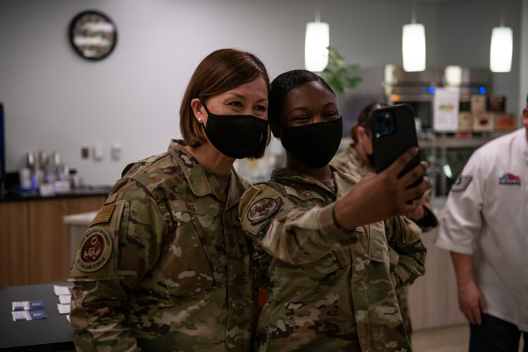 Chief Master Sgt. of the Air Force JoAnne Bass, left, takes a photo with an airman on Beale Air Force Base.