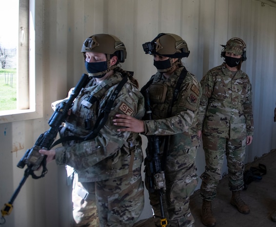 Chief Master Sgt. of the Air Force JoAnne Bass, right, watches as two airmen with the 9th Security Forces Squadron’s (SFS) tactical response team run through a building clearing demonstration on Beale Air Force Base