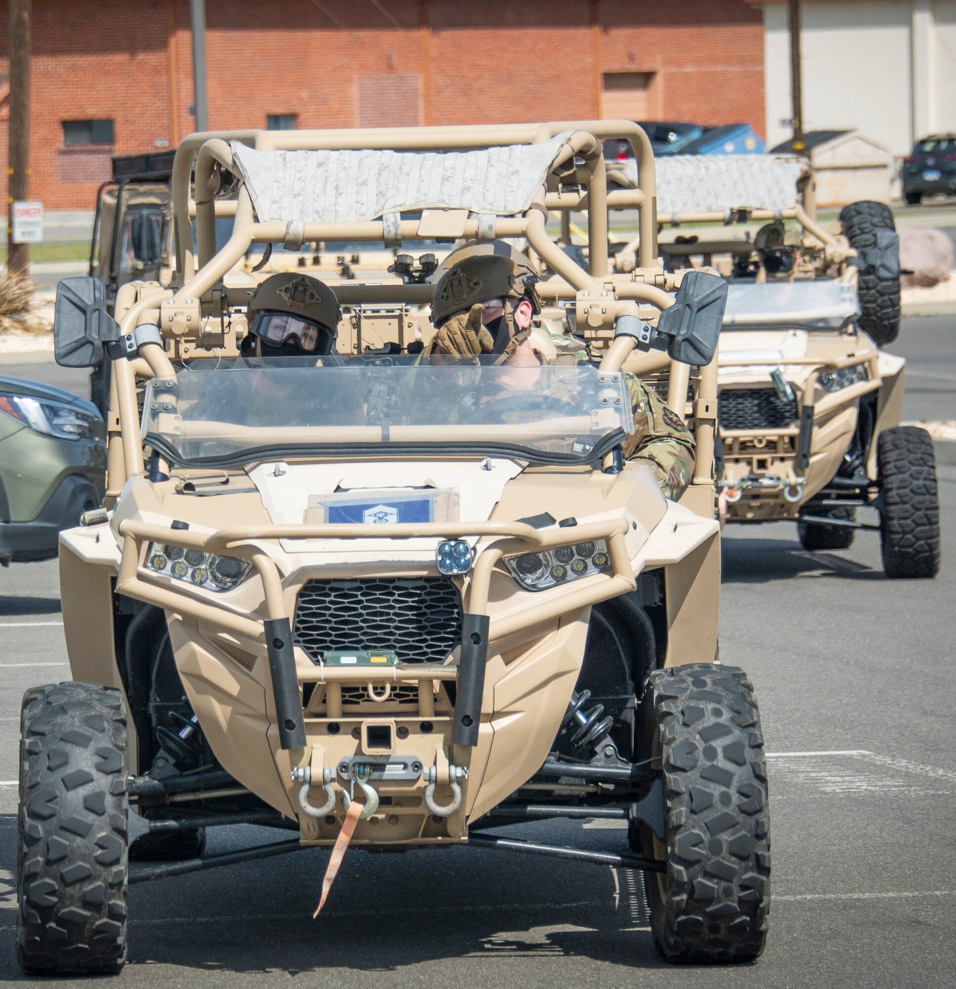 Chief Master Sergeant of the Air Force JoAnne S. Bass rides in an MRZR all-terrain vehicle while visiting the mighty Devil Raiders of the 621st Contingency Response Wing, Mar. 24, 2021, at Travis Air Force Base, California. During the visit, the 621st CRW Airmen presented a “Line of Fire” to introduce the wide range of logistic operations across the wing. (U.S. Air Force by Master Sgt. Liliana Moreno)
