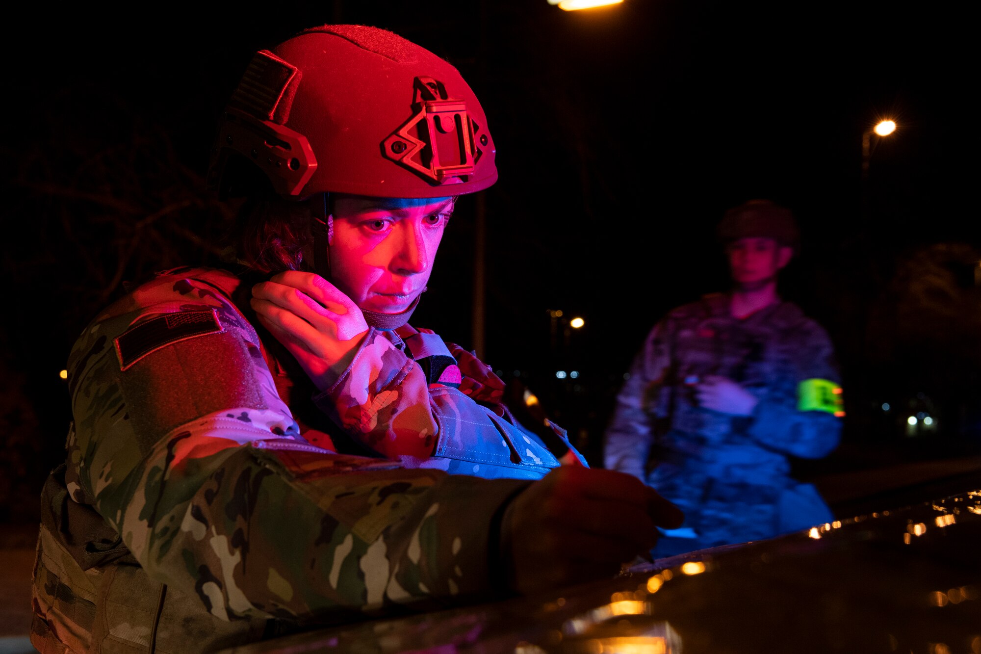 U.S. Air Force Tech. Sgt. Stephanie Gillie, 52nd Security Forces Squadron flight sergeant, communicates with Airmen from her squadron about a suspicious package as part of Exercise AGILE SABRE on Spangdahlem Air Base, Germany, March 25, 2021.