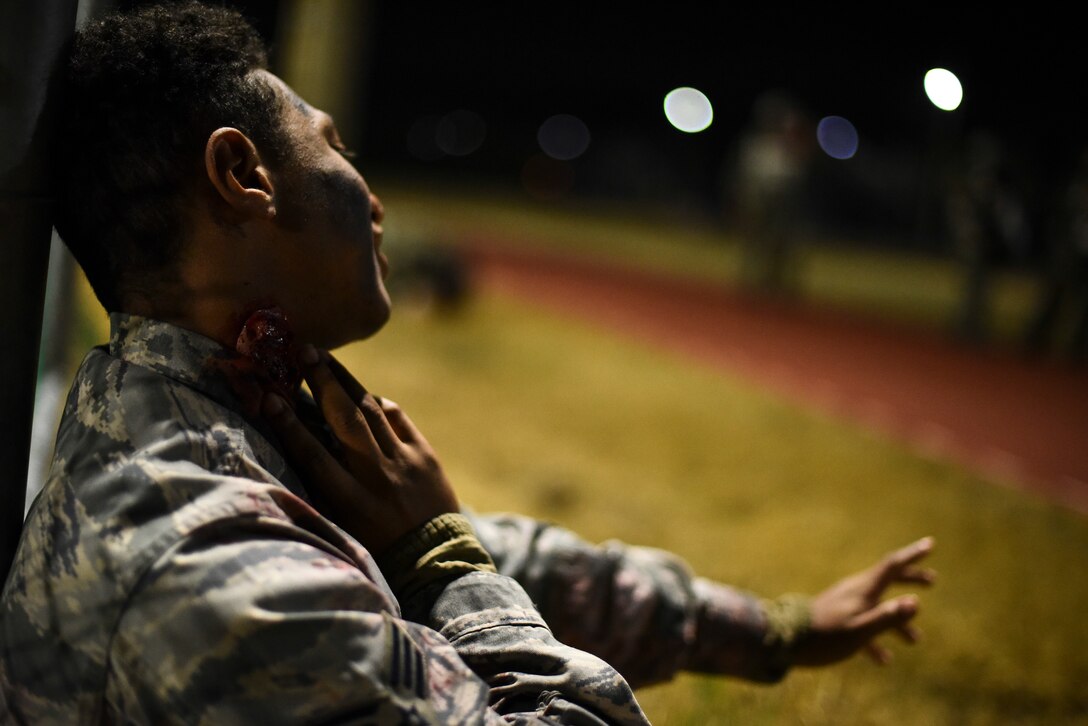 A simulated victim waits for medical treatment.