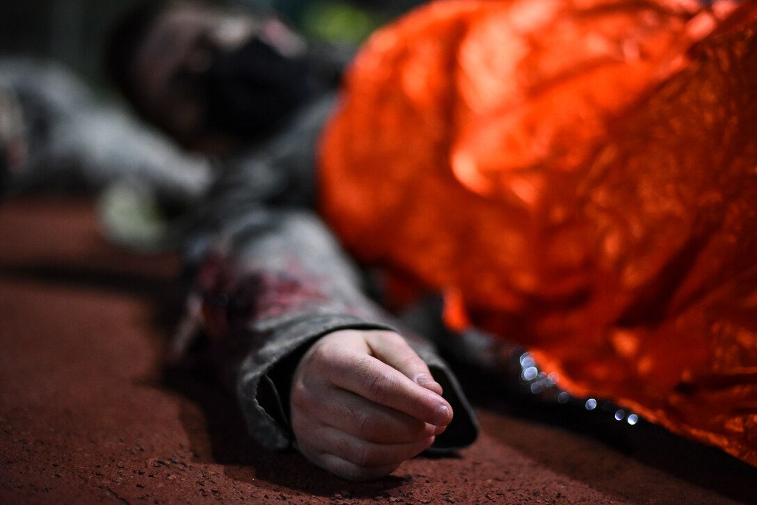 A simulated victim waits for medical treatment.