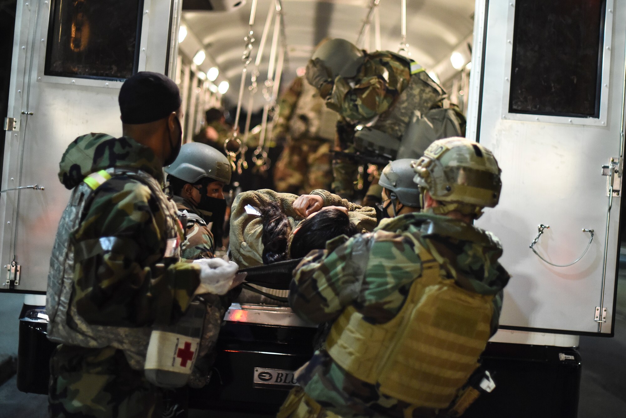 Airmen respond a simulated victim into a vehicle.