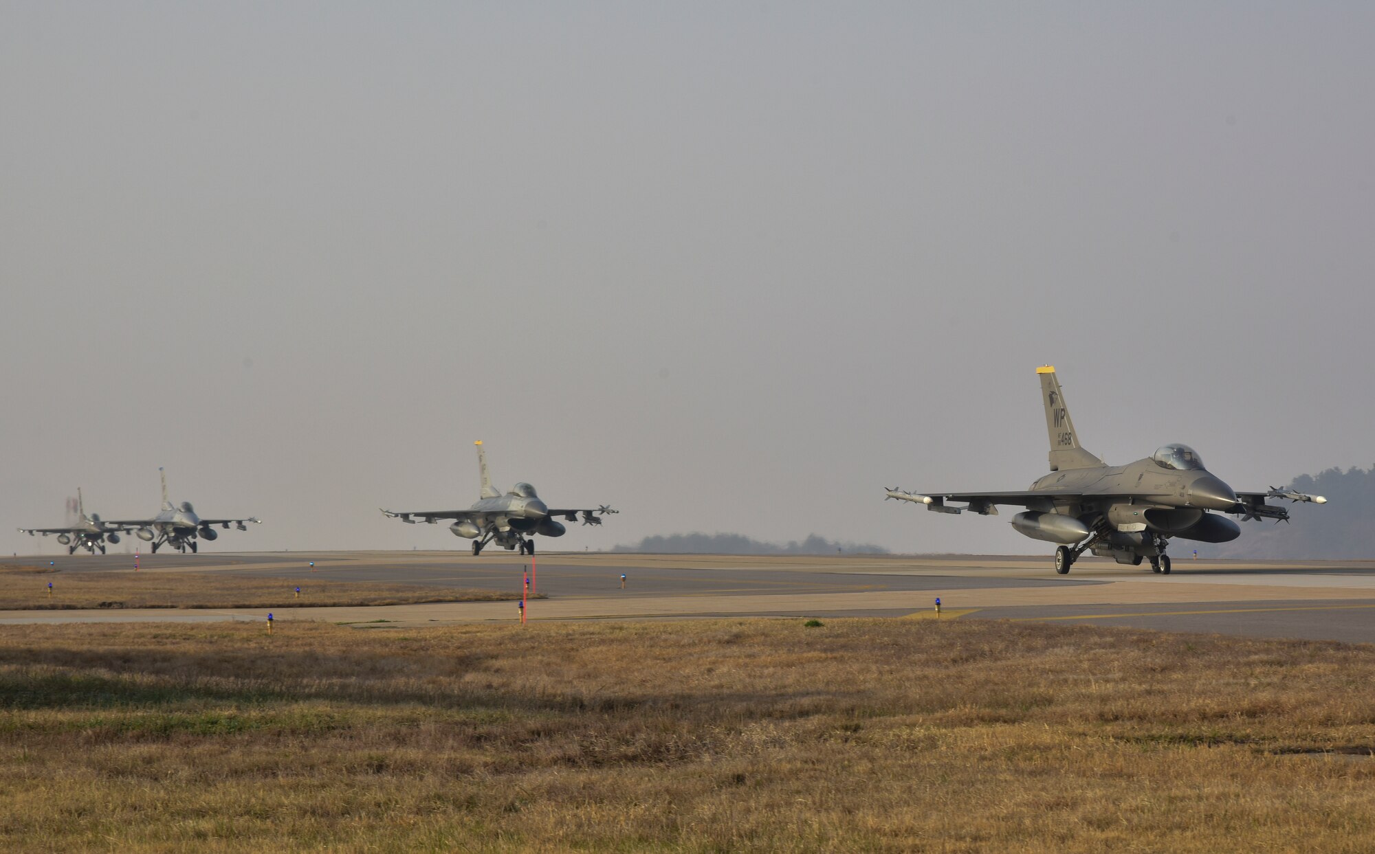 F-16 Fighting Falcons assigned to the 8th Fighter Wing taxi down the flightline at Kunsan Air Base, Republic of Korea, March 23, 2021. During the routine training event, F-16 Fighting Falcons landed, refueled and then took off for another sortie. (U.S. Air Force photo by Tech. Sgt. Kristin S. High)