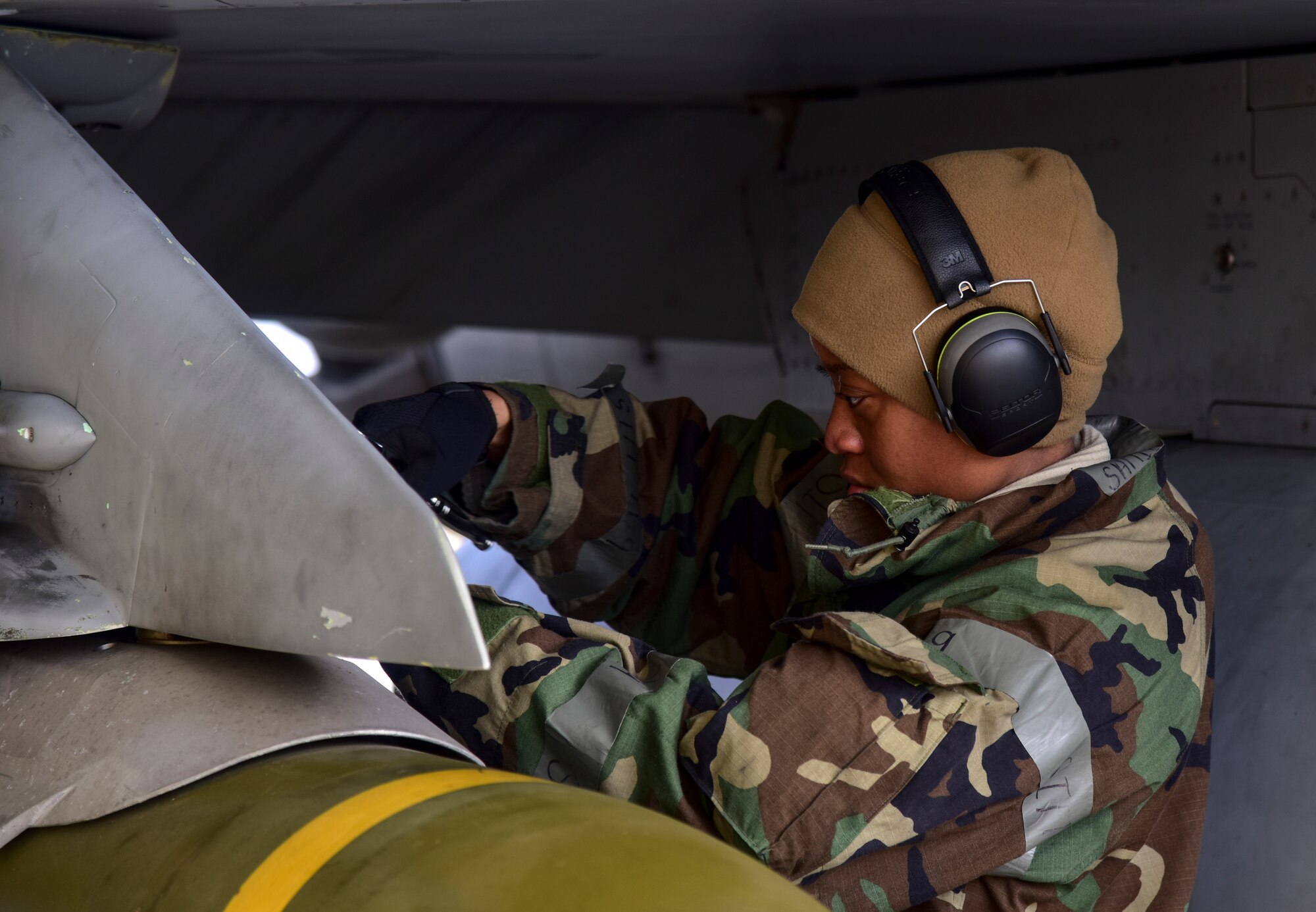 Staff Sgt. Samill Harkness, 35th Aircraft Maintenance Unit load crew member, tightens bolts while turning jets at Kunsan Air Base, Republic of Korea, March 23, 2021. During a routine training event, F-16 Fighting Falcons landed and quickly refueled before taking off for another sortie. (U.S. Air Force photo by Tech. Sgt. Kristin S. High)