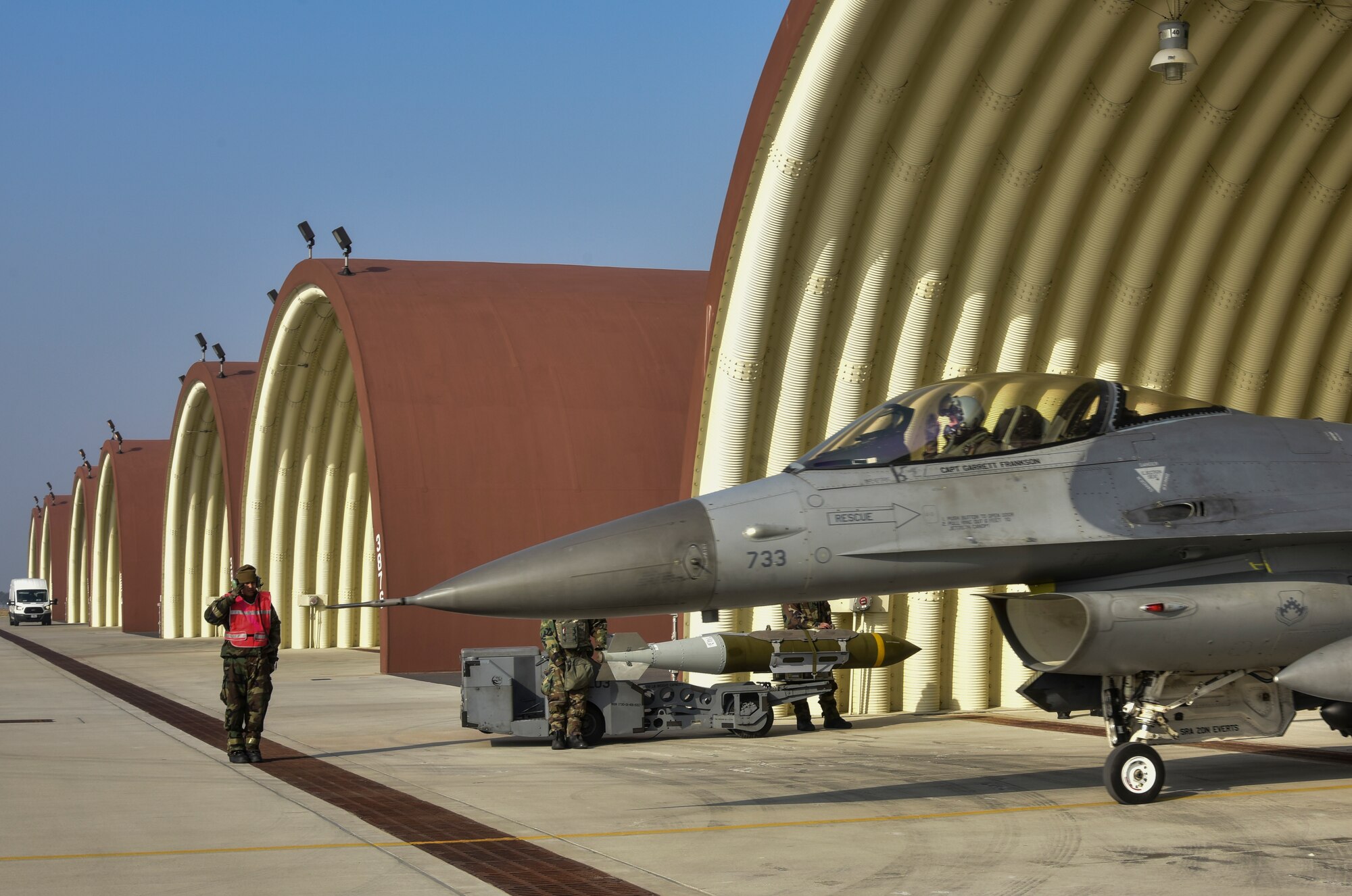 An Airman and pilot, both from the 8th Fighter Wing “Wolf Pack,” salute during a routine training event at Kunsan Air Base, Republic of Korea, March 23, 2021. The F-16 Fighting Falcons landed and quickly refueled before taking off for another sortie. (U.S. Air Force photo by Tech. Sgt. Kristin S. High)