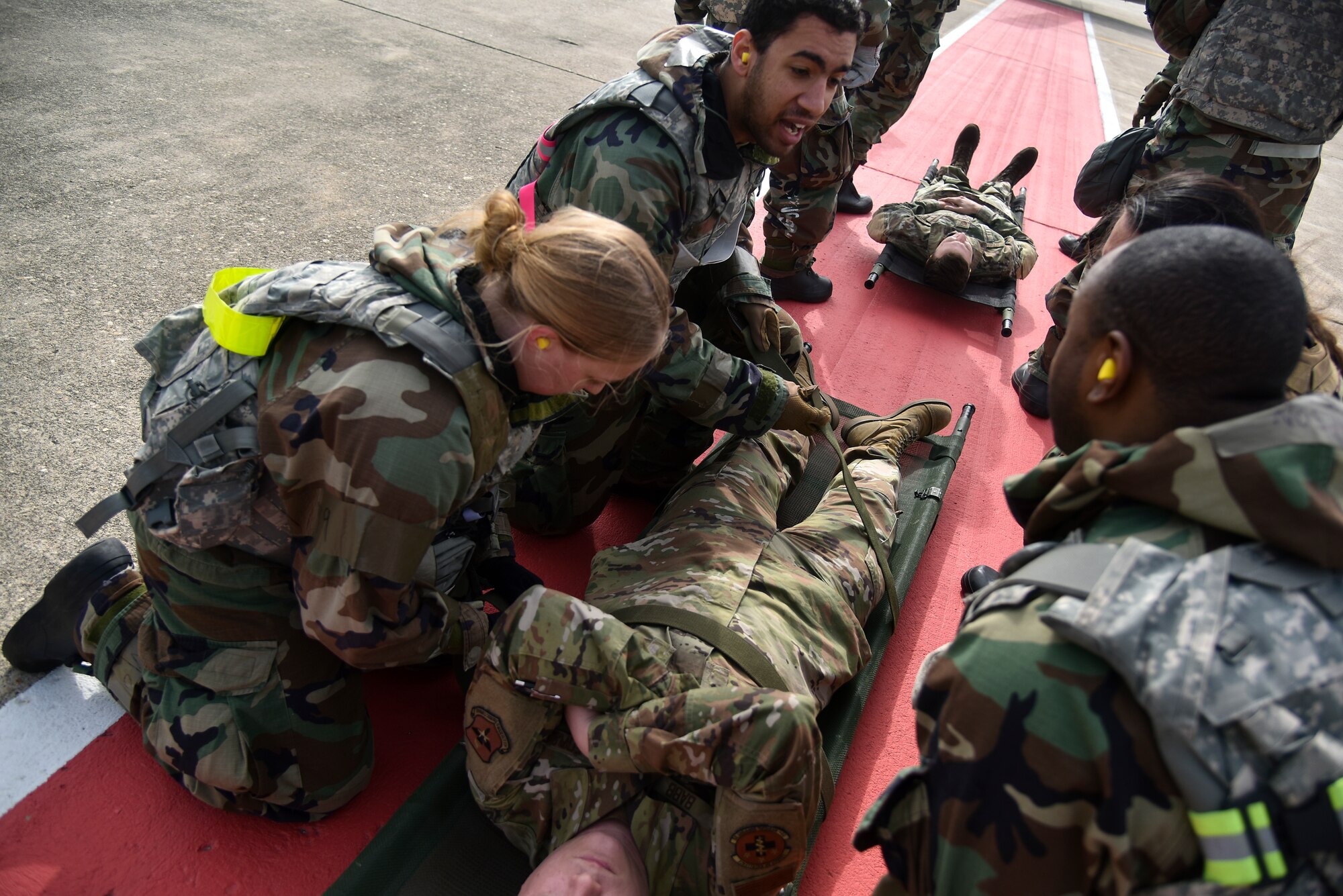 Eighth Medical Group Airmen secure a simulated patient to a gurney during a routine medical evacuation training event at Kunsan Air Base, Republic of Korea, March 25, 2021. The interagency training involved the 8th MDG “Med Hawks” and the 3-2 General Support Aviation Battalion from Camp Humphreys. (U.S. Air Force photo by Senior Airman Suzie Plotnikov)