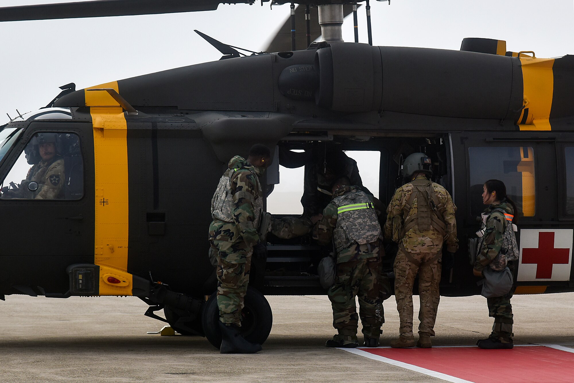Eighth Medical Group Airmen transport a simulated patient on an HH-60M Black Hawk helicopter during a routine medical evacuation training event at Kunsan Air Base, Republic of Korea, March 25, 2021. The 8th MDG “Med Hawks” and Soldiers from the 3-2 General Support Aviation Battalion, Camp Humphreys, utilized the Black Hawk to rapidly transport simulated victims for medical treatment. (U.S. Air Force photo by Senior Airman Suzie Plotnikov)
