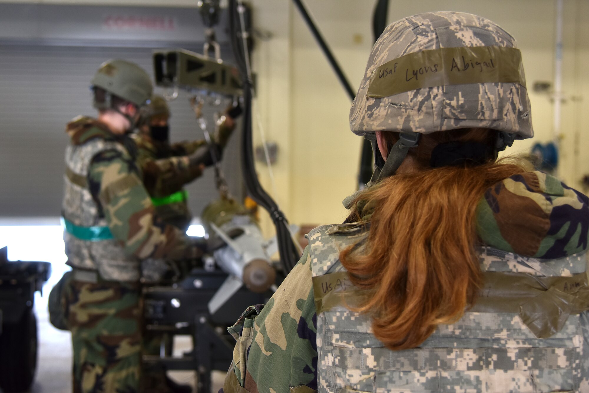 Airman Abigail Lyons, 8th Maintenance Squadron aircraft armament system technician, controls a hoist to move munitions during a routine training event at Kunsan Air Base, Republic of Korea, March 24, 2021. The 8th MXS “Dragons” build and maintain munitions for the 8th Fighter Wing. (U.S. Air Force photo by Senior Airman Suzie Plotnikov)
