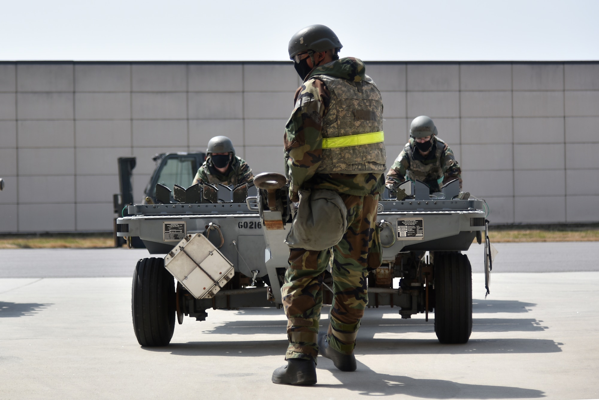 Eighth Maintenance Squadron Airmen move a trailer during a routine training event at Kunsan Air Base, Republic of Korea, March 24, 2021. The 8th MXS “Dragons” build and maintain munitions for the 8th Fighter Wing. (U.S. Air Force photo by Senior Airman Suzie Plotnikov)
