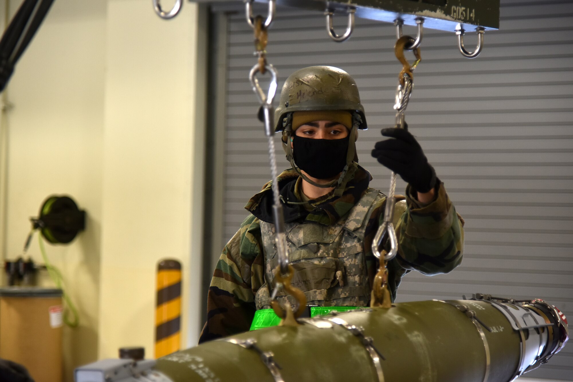Airman 1st Class Manuel Melendez, 8th Maintenance Squadron hydraulics specialist, uses a hoist to transport a munition during a routine training event at Kunsan Air Base, Republic of Korea, March 24, 2021. The 8th MXS “Dragons” build and maintain munitions for the 8th Fighter Wing. (U.S. Air Force photo by Senior Airman Suzie Plotnikov)