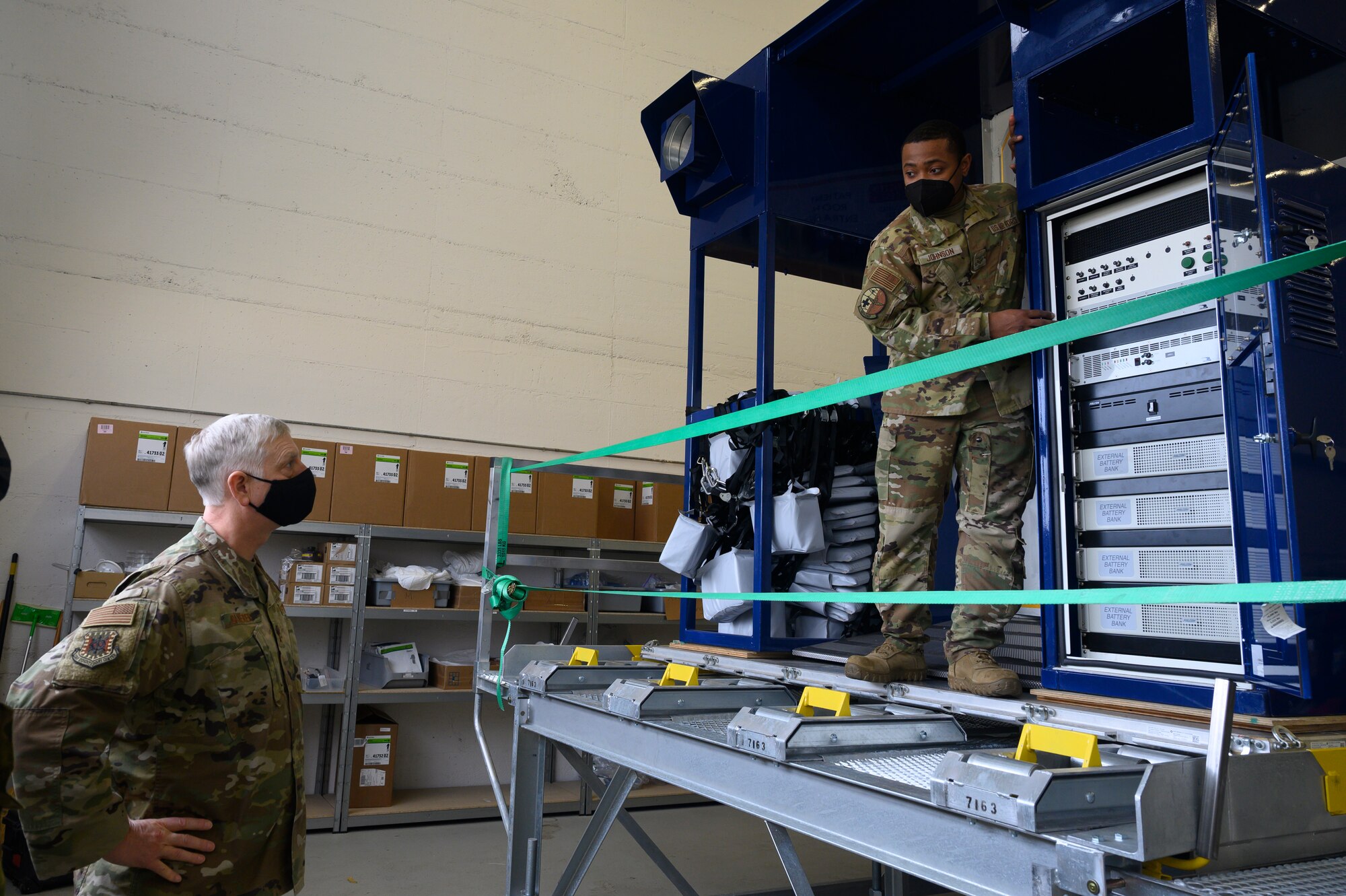 An Airman briefs another Airman on unit operations.