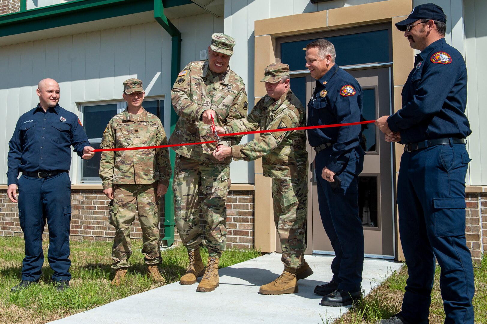 Maj. Gen. Michael Thompson, adjutant general for Oklahoma, and Col. Brad Carter, commander of Camp Gruber Training Center cut the ceremonial ribbon officially opening Fire Station Number 1 on Camp Gruber, Oklahoma, March 24, 2021. (Oklahoma National Guard photo by Anthony Jones)