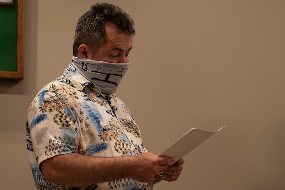 A photo of the 23d Wing Historian giving a speech during a ceremony.