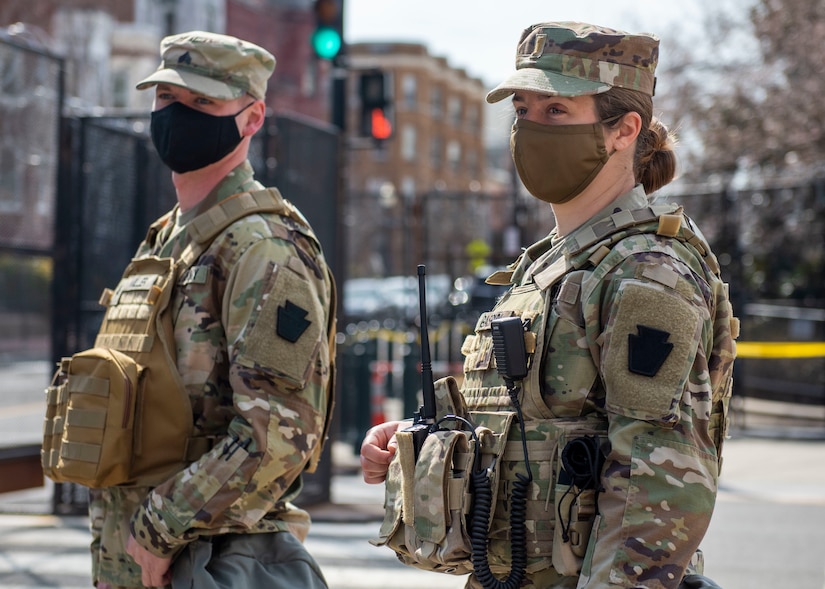 U.S. Army 2nd Lt. Analyse Gaspich, right, with the Pennsylvania National Guard, stands with a Soldier in Washington, D.C., March 9, 2021. The National Guard has been requested to continue supporting federal law enforcement agencies with security, communications, medical, evacuation, logistics, and safety support to state, district, and federal agencies through mid-March. (U.S. Air National Guard photo by Senior Airman Zoe M. Wockenfuss)