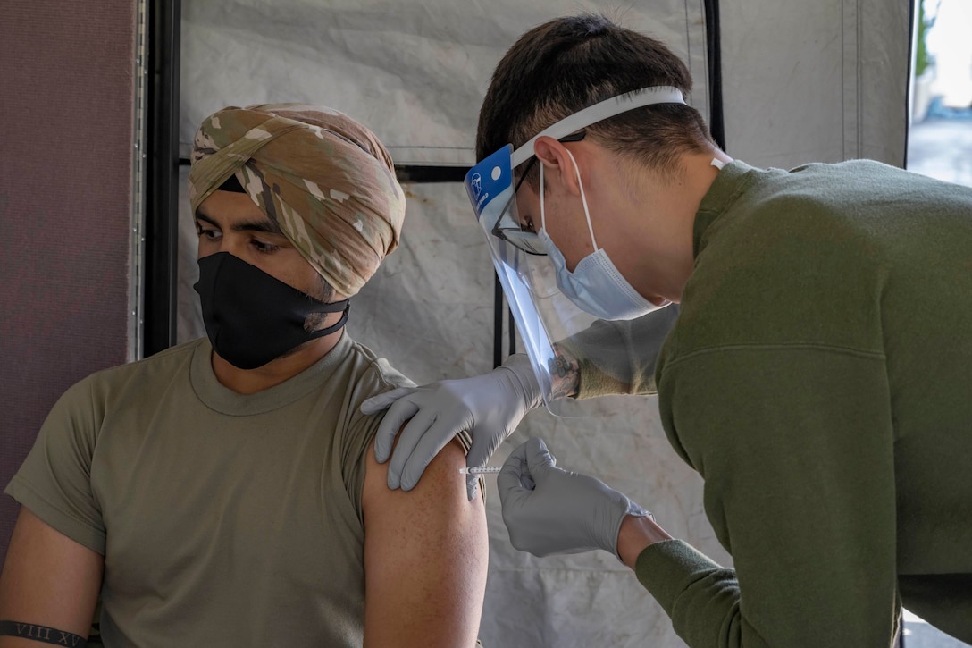 An airman gets vaccinated.