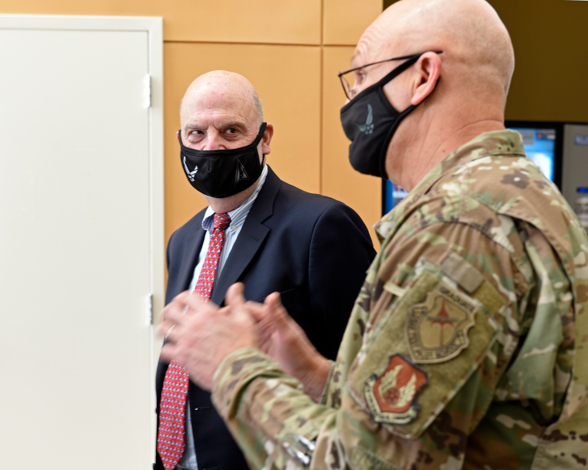 Acting Secretary of the Air Force John Roth, left, is briefed by Gen. Arnold W. Bunch Jr., commander, Air Force Materiel Command, before touring the U.S. Air Force School of Aerospace Medicine Epidemiology Laboratory at Wright-Patterson Air Force Base, Ohio, March 23, 2021.  The lab is responsible for analyzing a majority of the COVID-19 tests in the Air Force. Roth met with Air Force personnel and toured several facilities at the base including the National Air and Space Intelligence Center. (U.S. Air Force photo by Ty Greenlees)
