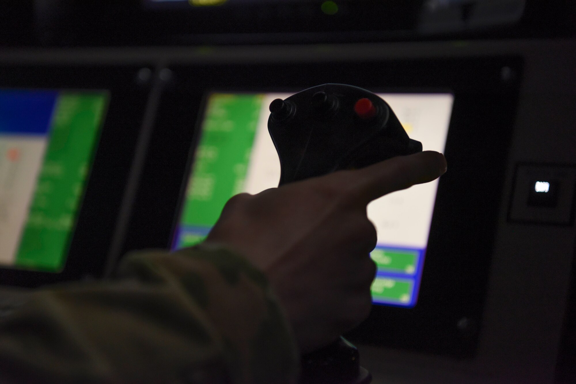 A U.S. Air Force remotely piloted aircraft sensor operator rests his hand on the sensor control at Chabelley Airfield, Djibouti, March 19, 2021. RPA sensor operators provide capabilities like surveillance, reconnaissance, close air support and real-time battle damage assessment, playing a vital role in ensuring mission success. (U.S. Air Force photo by Staff Sgt. Matthew J. Wisher)