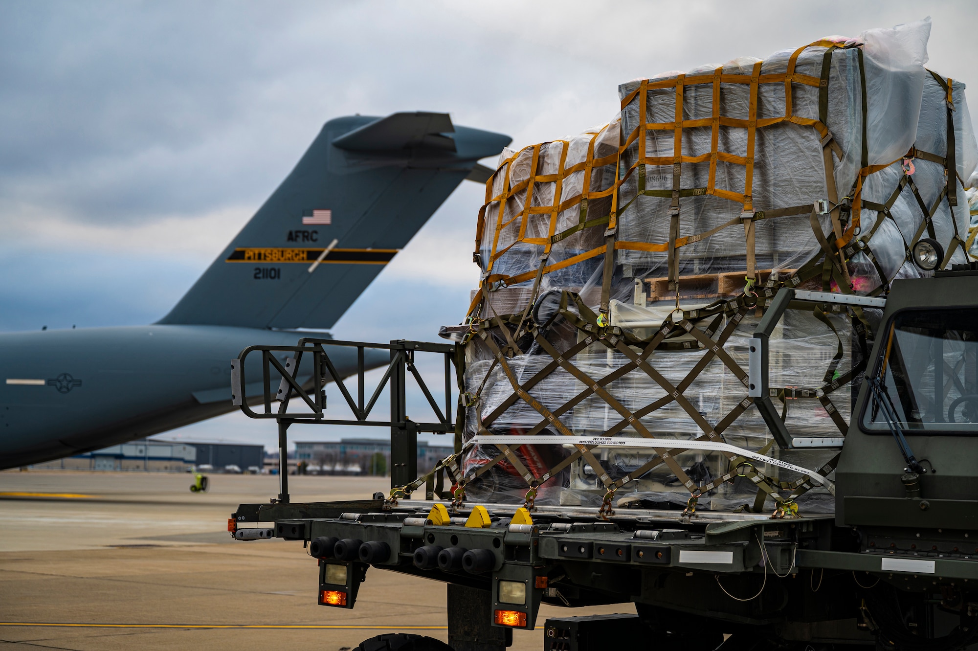 A Halvorsen Loader sits on the flight line with humanitarian aid for the Denton Program at the Pittsburgh International Airport Air Reserve Station, Pennsylvania, March 11, 2021.