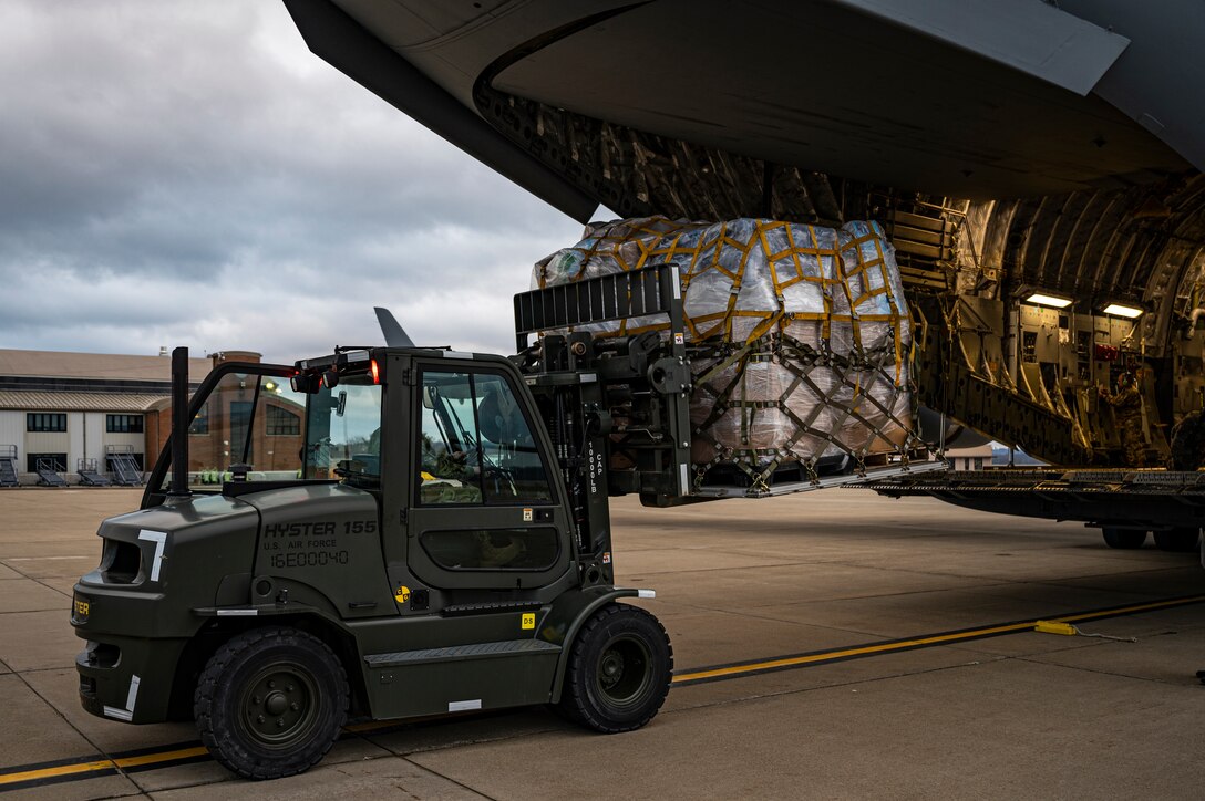 An Airman assigned to the 911th Logistics Readiness Squadron uses a forklift to load humanitarian aid for the Denton Program onto a C-17 Globemaster III at the Pittsburgh International Airport Air Reserve Station, Pennsylvania, March 11, 2021.