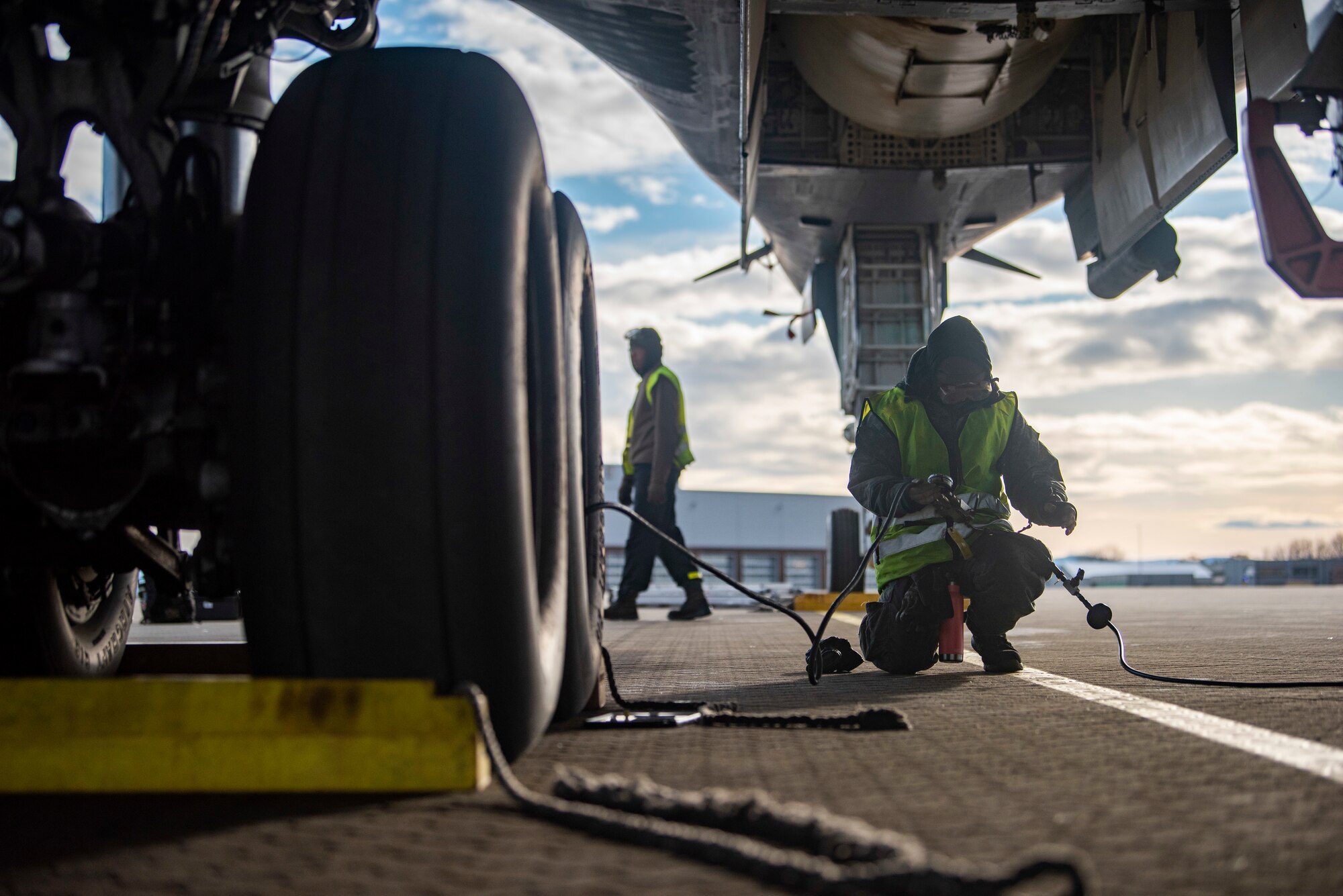 A crew chief assigned to the 9th Expeditionary Bomb Squadron services the landing gear on a B-1B Lancer at Ørland Air Force Station, Norway, March 13, 2021. Aircraft maintainers service the landing gear tires to ensure they are at the proper pounds per square inch needed to safely land the aircraft. (U.S. Air Force photo by Airman 1st Class Colin Hollowell)