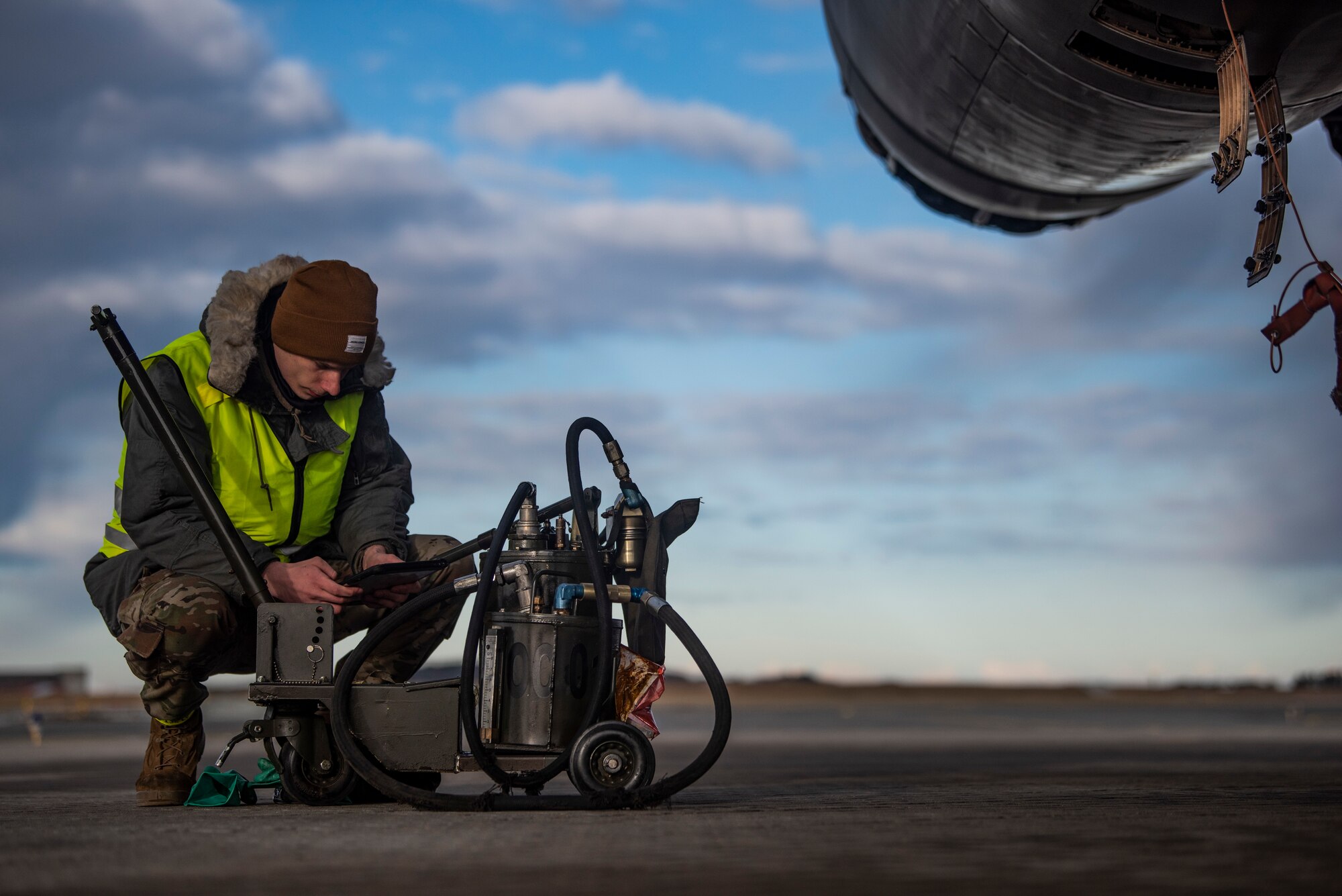 A crew chief assigned to the 9th Expeditionary Bomb Squadron reads an aircraft maintenance checklist at Ørland Air Force Station, Norway, March 13, 2021. Crew chiefs utilize checklists to track maintenance that has been performed on an aircraft. (U.S. Air Force photo by Airman 1st Class Colin Hollowell)