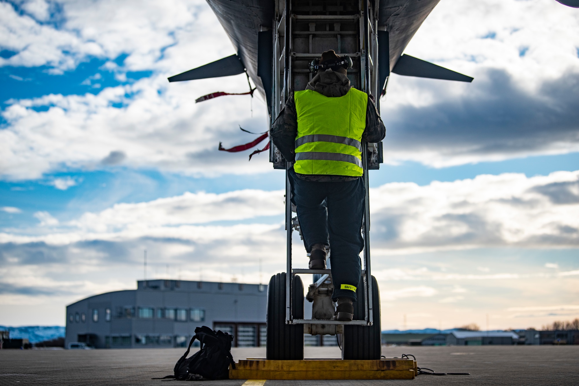 A crew chief assigned to the 9th Expeditionary Bomb Squadron climbs into the cockpit of a B-1B Lancer at Ørland Air Force Station, Norway, March 13, 2021. Aircraft maintainers conduct pre-flight systems checks to ensure the aircraft is safe to fly. (U.S. Air Force photo by Airman 1st Class Colin Hollowell)