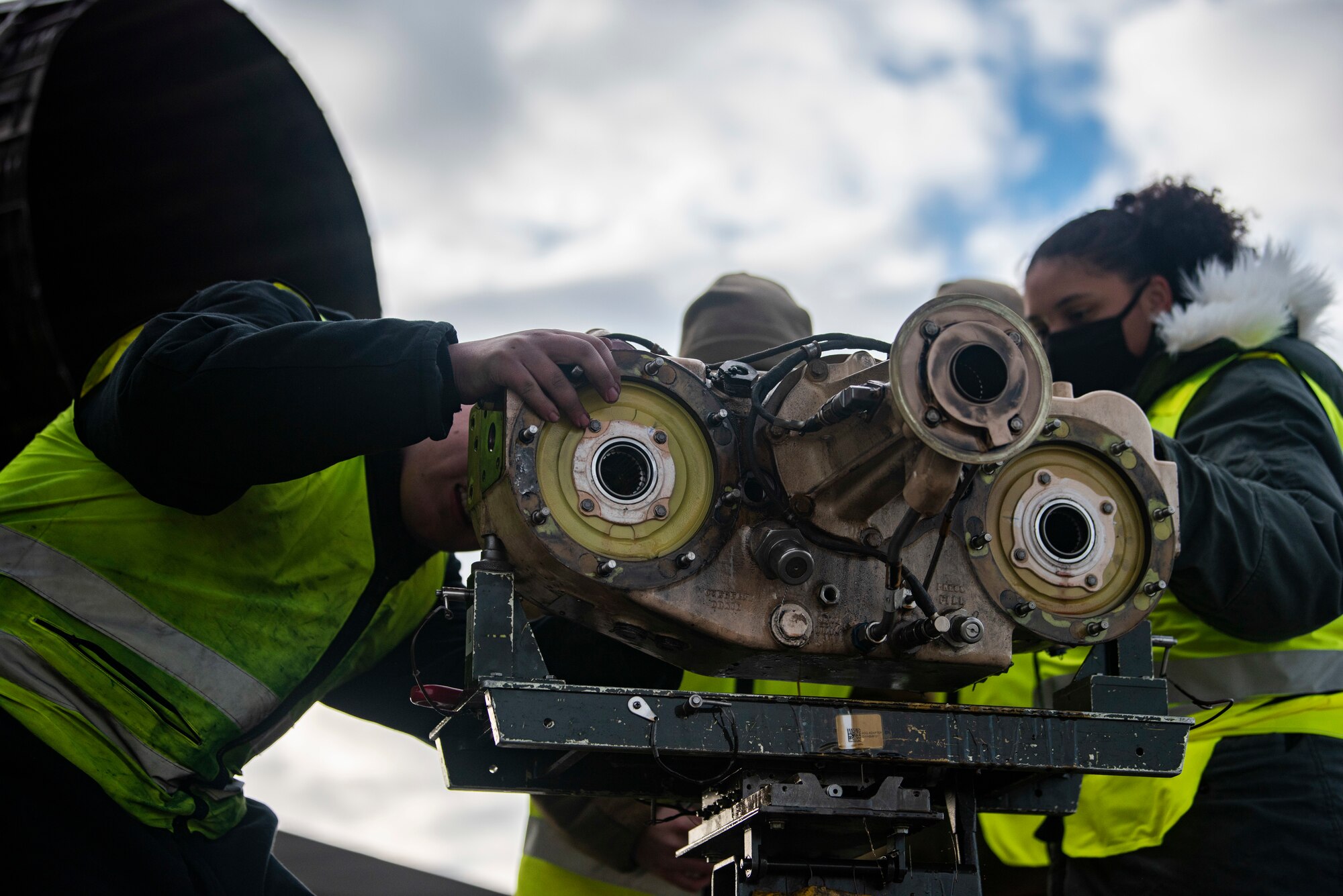 Crew chiefs assigned to the 9th Expeditionary Bomb Squadron inspect the accessory drive gearbox of a B-1B Lancer at Ørland Air Force Station, Norway, March 13, 2021. The accessory drive gearbox was removed, inspected and replaced as part of routine aircraft safety maintenance. (U.S. Air Force photo by Airman 1st Class Colin Hollowell)