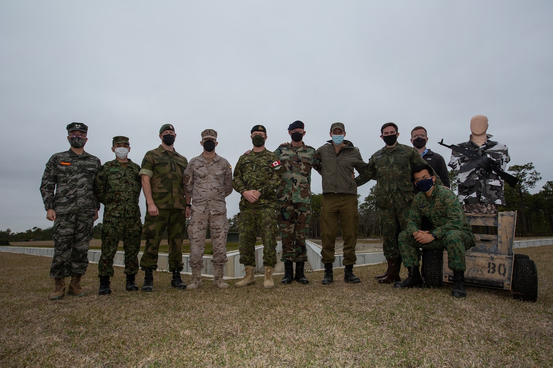 Foreign liaison officers pose for a group photo at Range 36 on Marine Corps Base Camp Lejeune, Mar. 17.