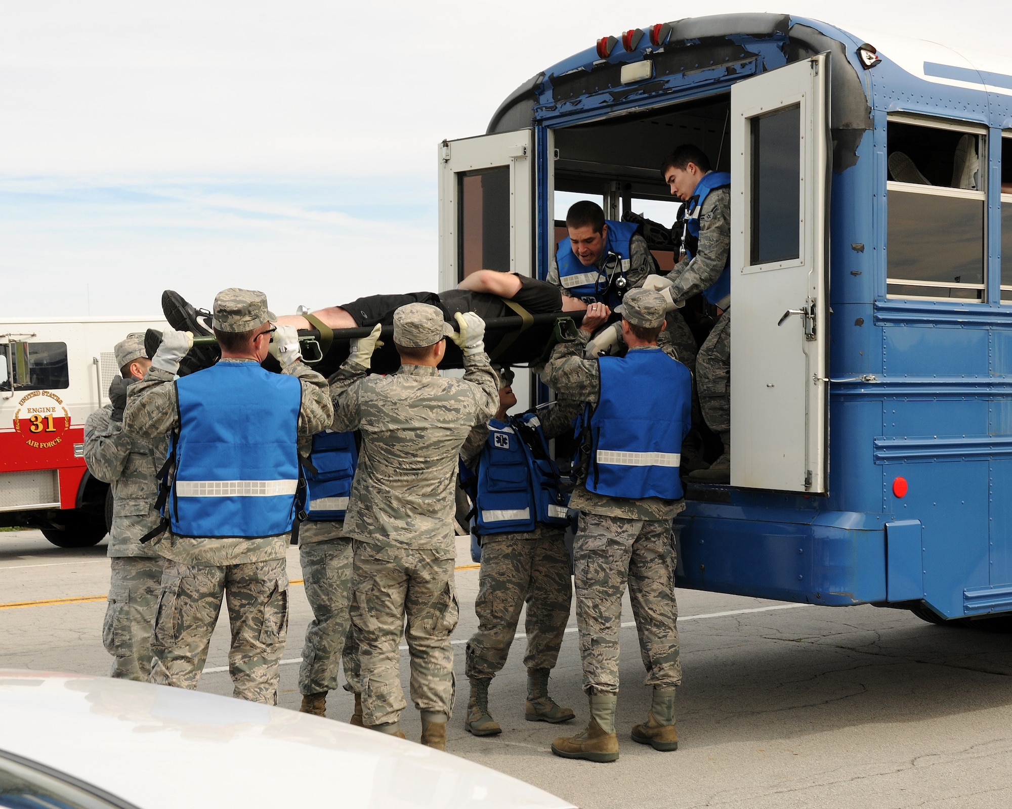Wright-Patterson AFB first responders load a volunteer “victim” onto a vehicle for emergency transport during a May 2013 tornado exercise. Response action is expected of all personnel during the March 31 base-wide drill.