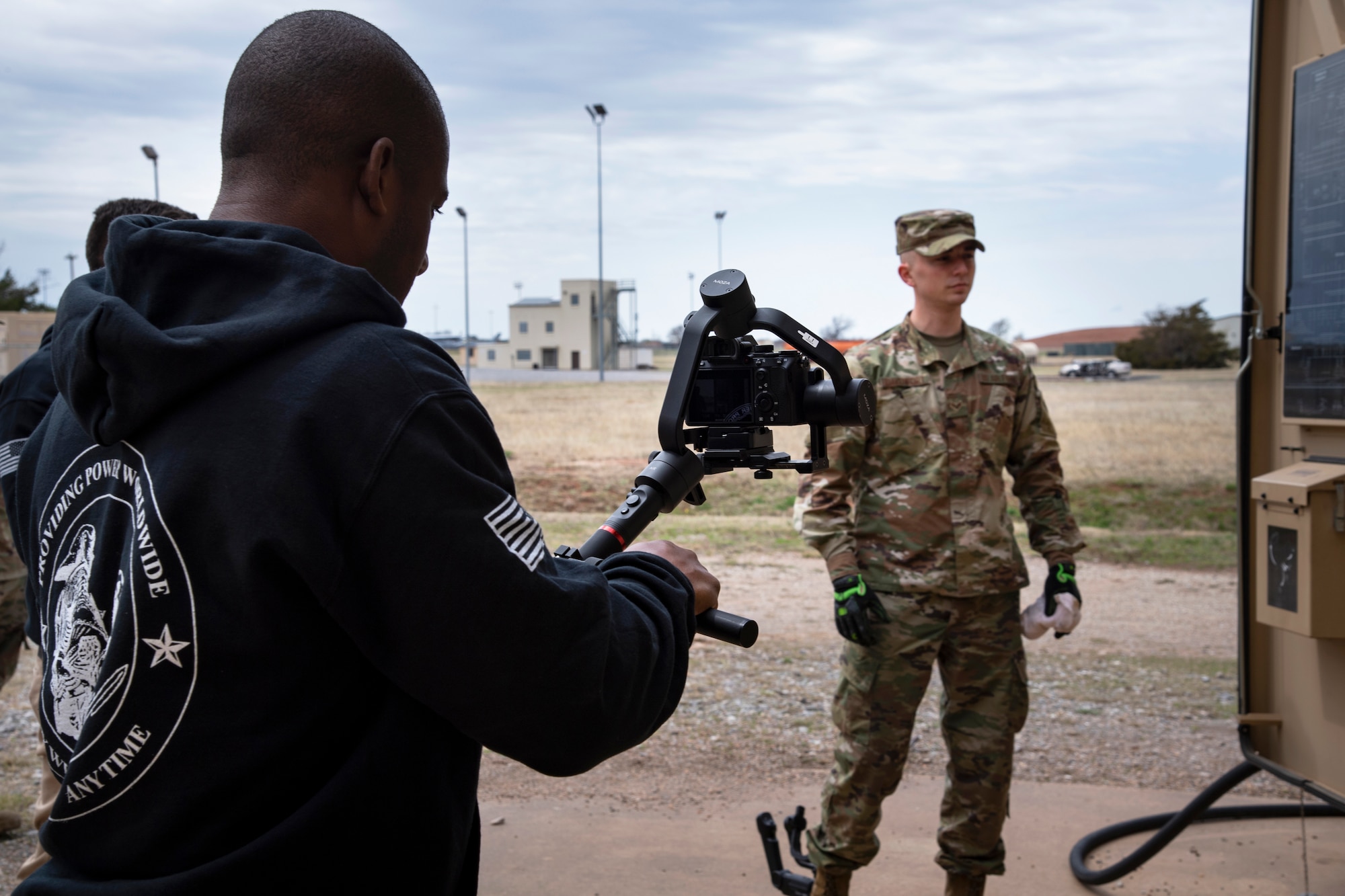 Lorenzo Burleson, A4C Strategic Communications, films Senior Airman Austin Davenport, 316th Civil Engineering Squadron electrical power production specialist, at Sheppard Air Force Base, Texas, March 24, 2021. The electrical power production career field is modernizing their career development courses, moving from paper study guides to interactive photos, videos and reviews online. (U.S. Air Force photo by Senior Airman Pedro Tenorio)