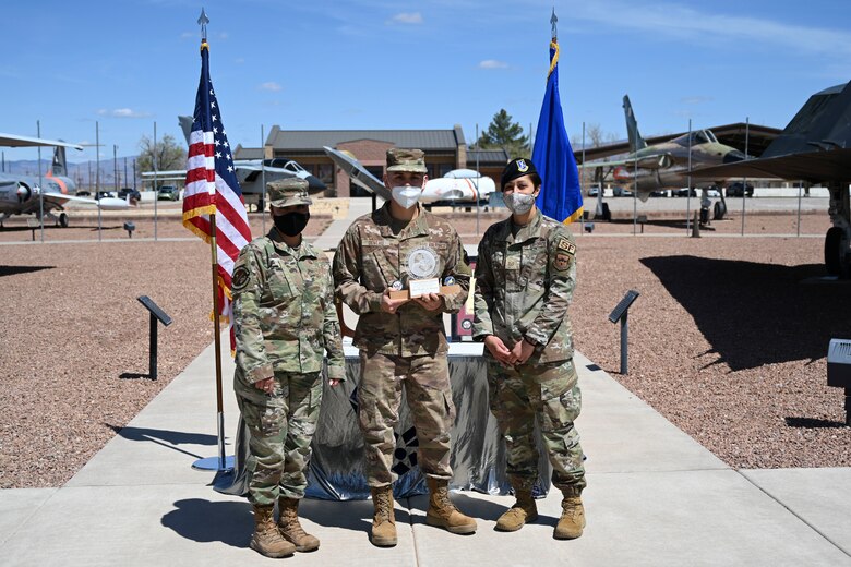 An Airman is handed an ALS award.