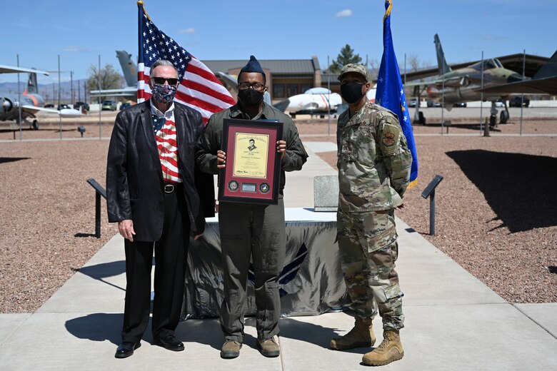 An Airman is handed an ALS award.