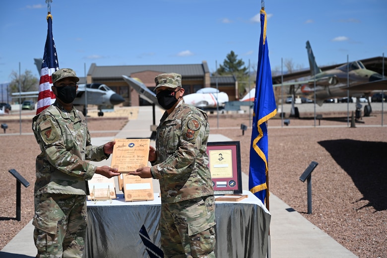 An Airman is handed an ALS award.