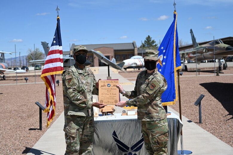 An Airman is handed an ALS award.