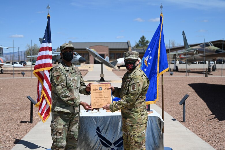 An Airman is handed an ALS award.