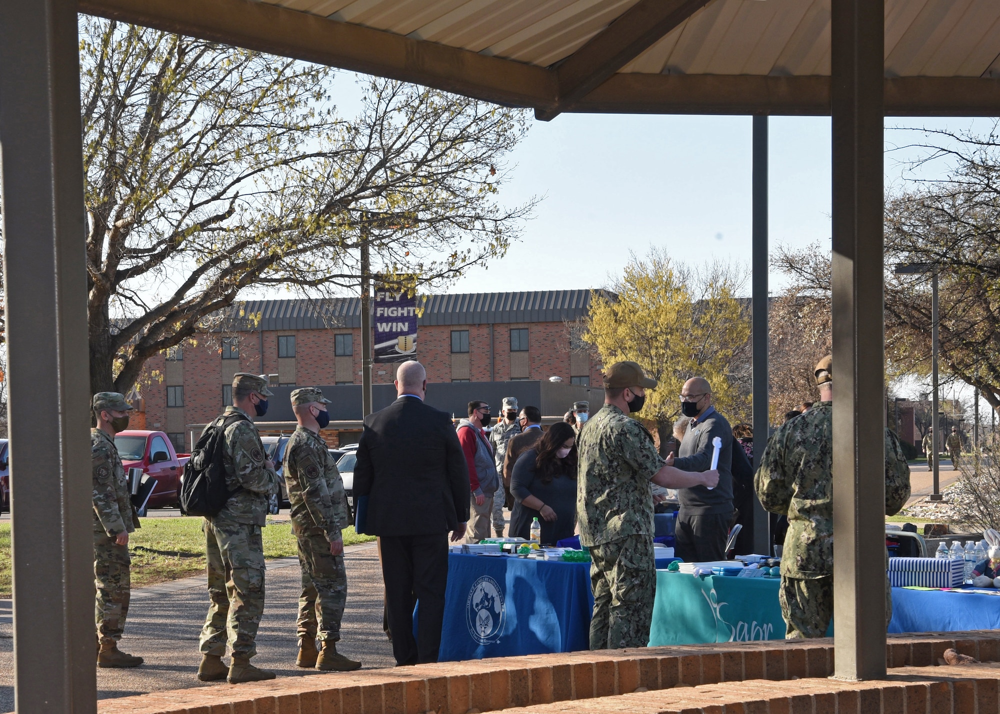 Joint service members and civilian personnel explore information booths at the proclamation signing ceremony for the 2021 Month of Awesomeness and Awareness, outside of the Western Winds Dining Facility, on Goodfellow Air Force Base, Texas, March 25, 2021.  The event hosted several agencies to help identify the available resources and information for military children, child abuse prevention, sexual assault prevention and response, alcohol abuse prevention and national financial capability. (U.S. Air Force photo by Senior Airman Abbey Rieves)