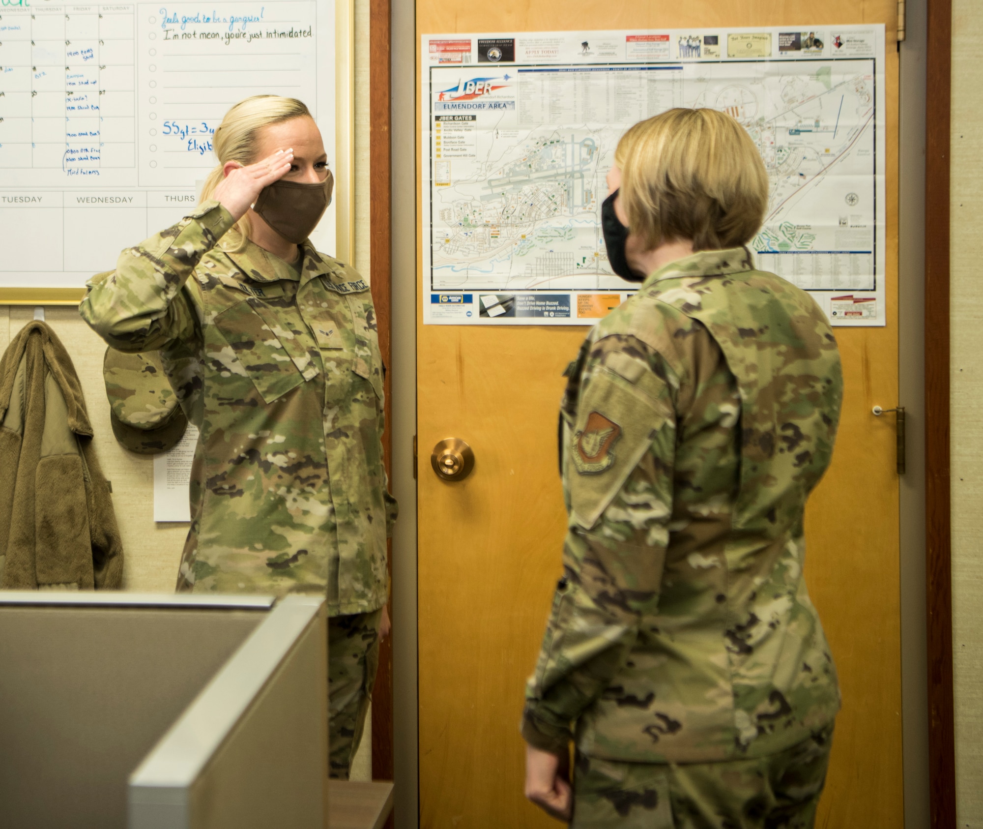 U.S. Space Force Specialist 3 Chanda Holter, a 673d Communications Squadron knowledge manager, salutes U.S. Air Force Col. Kirsten Aguilar, Joint Base Elmendorf-Richardson and 673d Air Base Wing commander, after receiving a coin during an immersion tour at JBER, Alaska, March 19, 2021. The focus of Aguilar’s tour was to get to know the 673d CS Airmen and familiarize herself with the squadron’s different sections and each one’s role in supporting the base.