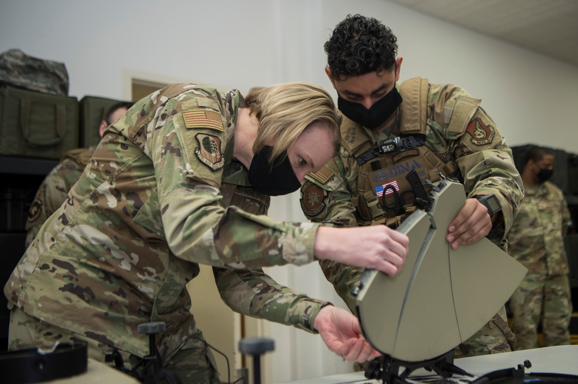 U.S. Air Force Col. Kirsten Aguilar, Joint Base Elmendorf-Richardson and 673d Air Base Wing commander and U.S. Air Force Senior Airman Desmond Medina, a 673d Communications Squadron cyber control operator, build a multi-mission terminal during an immersion tour at JBER, Alaska, March 19, 2021. The focus of Aguilar’s tour was to get to know the 673d CS Airmen and familiarize herself with the squadron’s different sections and each one’s role in supporting the base.