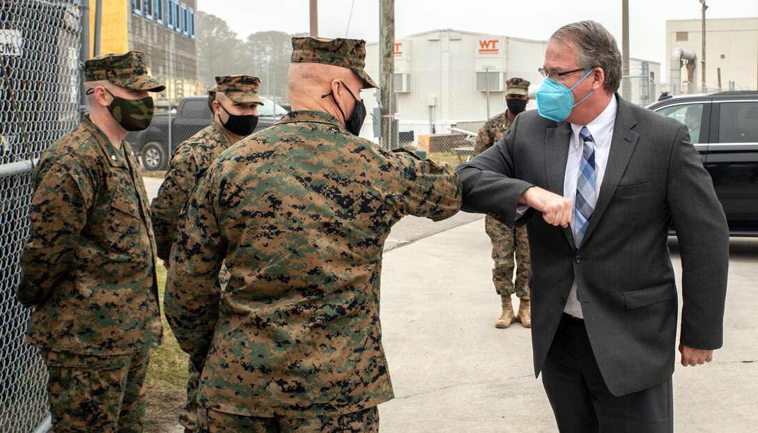 The Honorable Thomas W. Harker, Secretary of the Navy (Acting) is greeted by U.S. Marine Corps Brig. Gen. William Souza, Deputy Commander, Mobilization, Fleet Marine Force Atlantic, U.S. Marine Corps Forces Command, and U.S. Marine Corps Forces Northern Command and Marines assigned to Alpha Company 4th Assault Amphibian Battalion at the beginning of Harker’s visit to Joint Expeditionary Base Little Creek-Fort Story in Virginia Beach, Virginia, February 17, 2021. Secretary Harker visited various commands across the Mid-Atlantic region to meet with Sailors and Marines. (U.S. Marine Corps Photo by Mr. Jonathan Donnelly/Released)