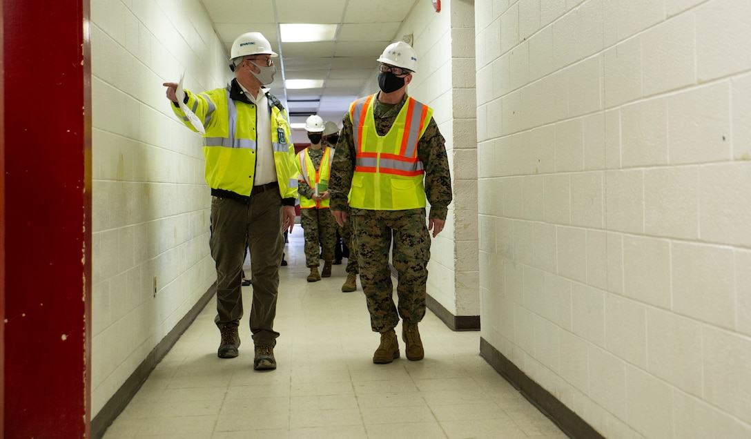 U.S. Marine Corps Lt. Gen. Robert F. Hedelund, Commanding General, Fleet Marine Force Atlantic, and Commander, U.S. Marine Corps Forces Command, U.S. Marine Corps Forces Northern Command is escorted through the Marine Camp Elmore (MCE-9) building by Mr. Bill Crone, Construction Director for Navy Facilities Engineering Systems Command (NAVFAC) Mid-Atlantic at Camp Elmore in Norfolk, Virginia, March 24, 2021. This meeting signifies the start of converting previously used training rooms, classrooms, and administrative offices into fully-functioning, mission-capable headquarters spaces in support of the Commandant’s force restructure initiatives. The interior reconfiguration will accommodate the new P&O, South detachment. The upgraded administrative workspaces will be occupied by personnel assigned to manpower, reserve integration, plans, forward-deployed plans and execution, global force analysis, aviation force analysis, and readiness functions. The renovation is slated to be complete in August of 2021. (U.S. Marine Corps Photo by Mr. Jonathan Donnelly/Released)