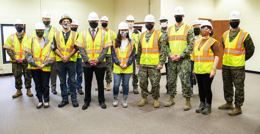 U.S. Marine Corps Lt. Gen. Robert F. Hedelund, Commanding General, Fleet Marine Force Atlantic, and Commander, U.S. Marine Corps Forces Command, U.S. Marine Corps Forces Northern Command poses for a group photo with members of Navy Facilities Engineering Systems Command (NAVFAC) Mid-Atlantic and Heritage Contracting in the Marine Camp Elmore (MCE-9) building at Camp Elmore in Norfolk, Virginia, March 24, 2021. This meeting signifies the start of converting previously used training rooms, classrooms, and administrative offices into fully-functioning, mission-capable headquarters spaces in support of the Commandant’s force restructure initiatives. The interior reconfiguration will accommodate the new P&O, South detachment. The upgraded administrative workspaces will be occupied by personnel assigned to manpower, reserve integration, plans, forward-deployed plans and execution, global force analysis, aviation force analysis, and readiness functions. The renovation is slated to be complete in August of 2021. (U.S. Marine Corps Photo by Mr. Jonathan Donnelly/Released)