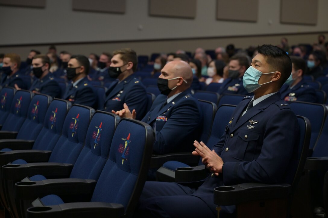 Student pilots of Specialized Undergraduate Pilot Training class 21-07 clap for the commencement of the graduation ceremony, March 26, 2021, on Columbus Air Force Base, Miss. To earn Air Force wings, each student flies nearly 200 hours during a 54-week period. (U.S. Air Force photo by Senior Airman Jake Jacobsen)