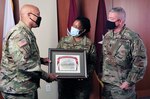 Brig. Gen. Shan Bagby (left), Brooke Army Medical Center commanding general, and BAMC Command Sgt. Maj. Thurman Reynolds (right) present Lt. Col. Alison Murray, chief medical information officer, a certificate of appreciation for being the guest speaker during BAMC’s Virtual Women’s History Month observation March 26. BAMC broadcasted the event on Facebook live in order to social distance during the current COVID-19 pandemic.