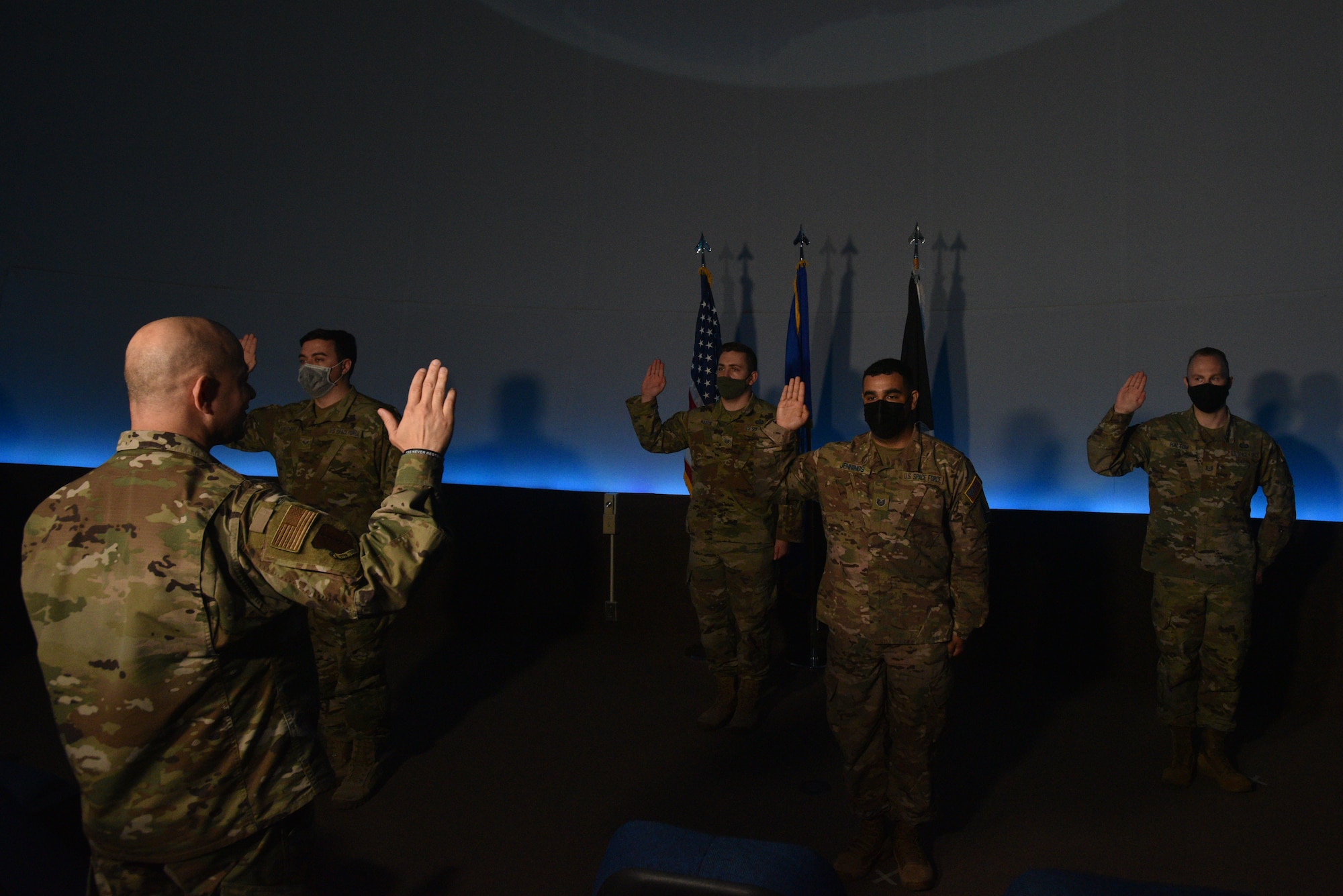 U.S. Air Force Col. Andres Nazario, 17th Training Wing commander, administers the oath of enlistment to the Space Force’s newest Guardians at Angelo State University’s Planetarium in San Angelo, Texas, March 26, 2021. Since December 20, 2019, the Space Force continues to train and equip Guardians to protect and defend our nation.  (U.S. Air Force photo by Senior Airman Ashley Thrash)